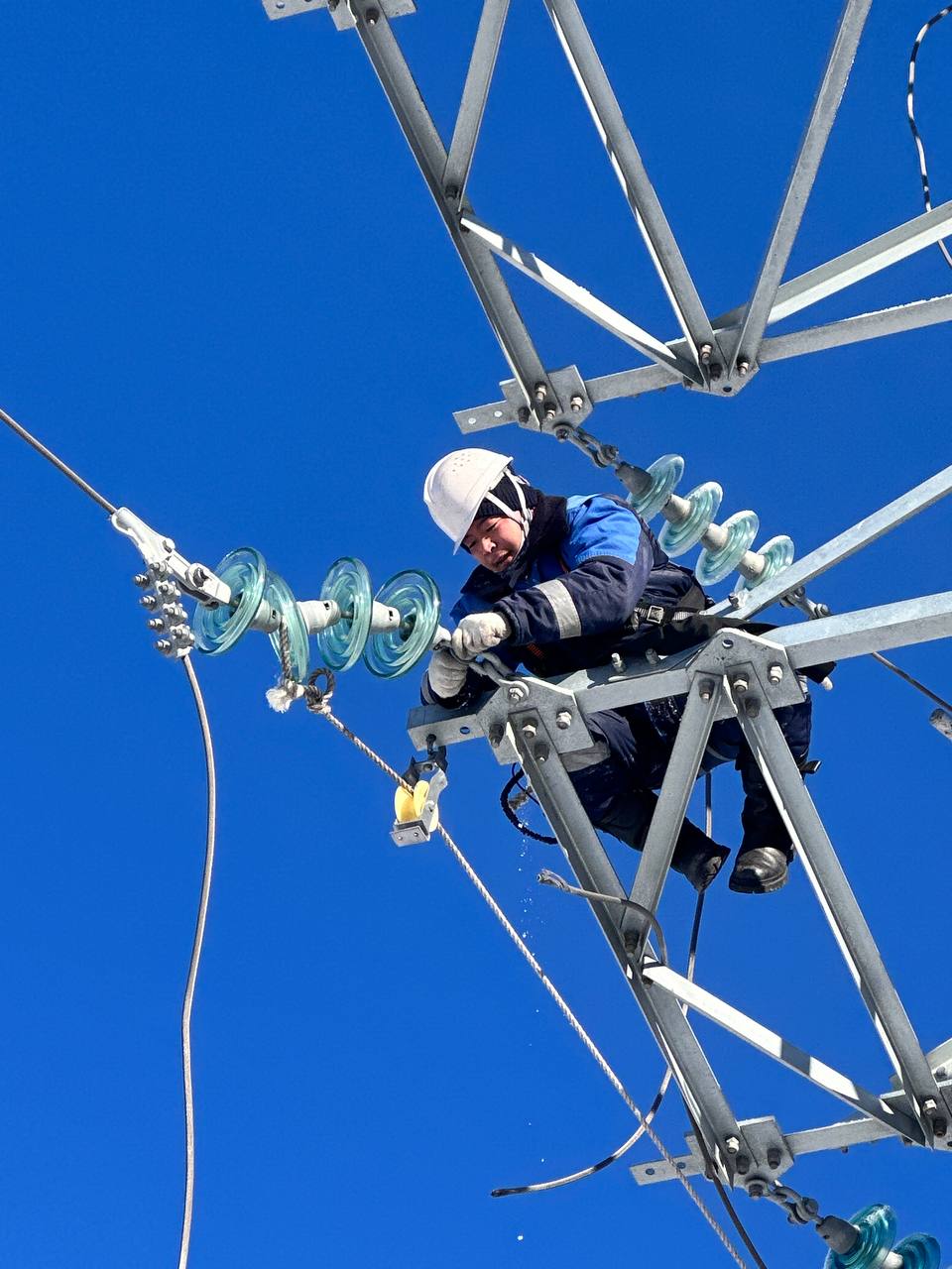 Lineman working on high-voltage tower